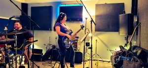 Mimi on bass and Wyatt observing from behind the drums